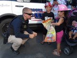 A Lemoore officer greets a National Night Out enthusiast as Tanglewoood Apartments.